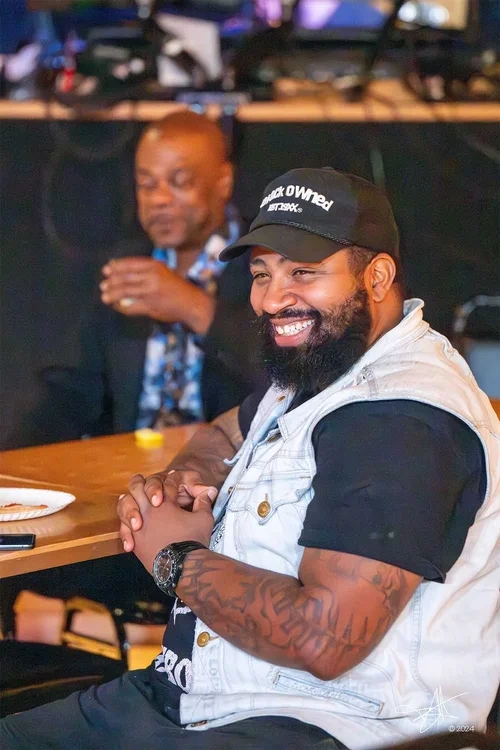 Corporate event candid photography by Deborah Heinlen Photography, Cincinnati — man with beard laughing during a corporate networking event