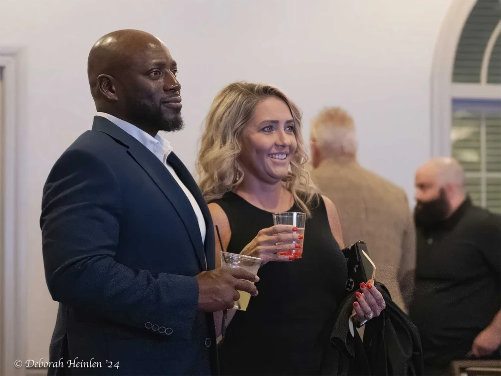 Corporate event candid photography by Deborah Heinlen Photography, Cincinnati — smiling woman with blonde hair at a corporate networking event