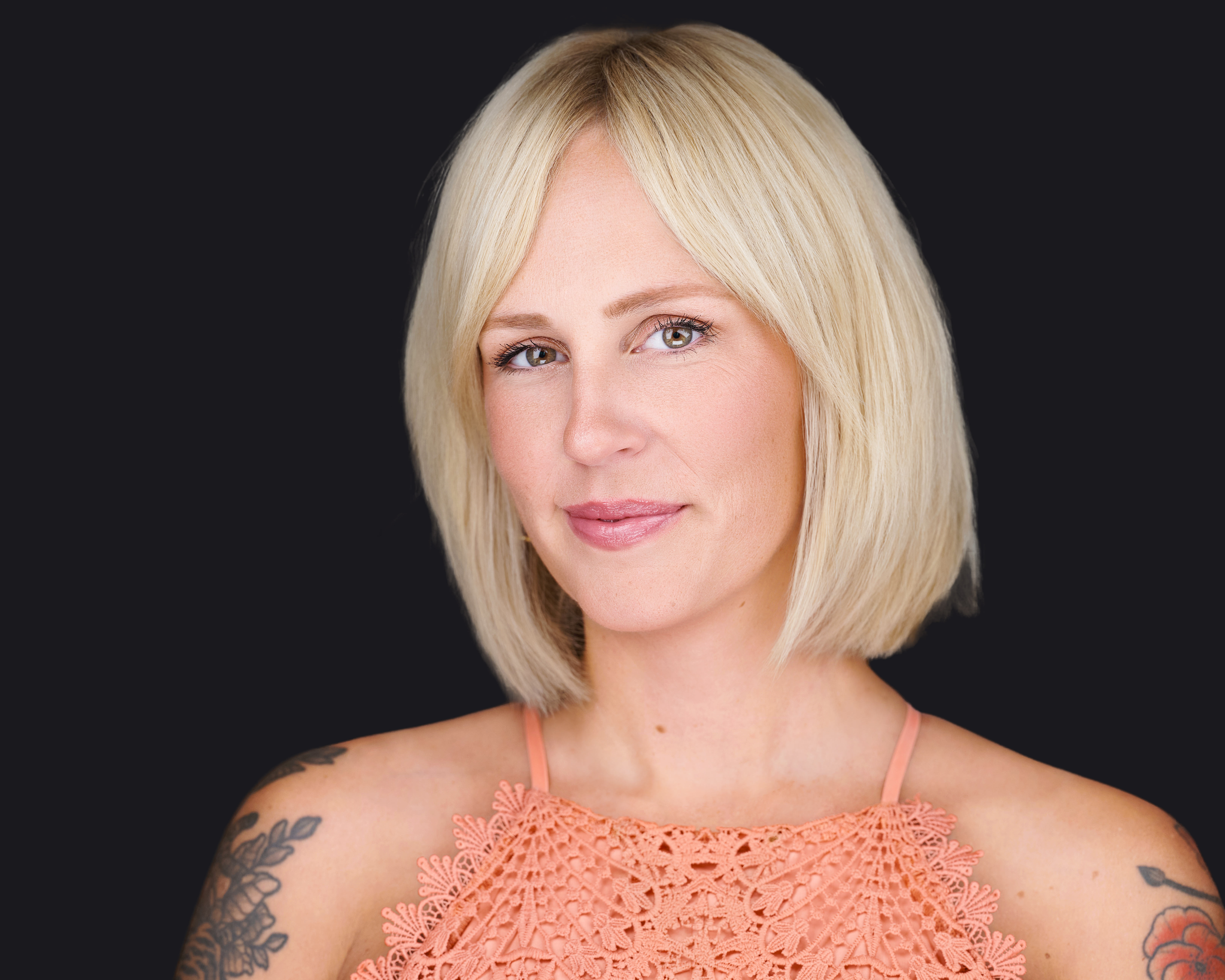 Professional headshot example for the Express Session package by Deborah Heinlen Photography, Cincinnati — smiling woman with blonde hair and a peach color shirt