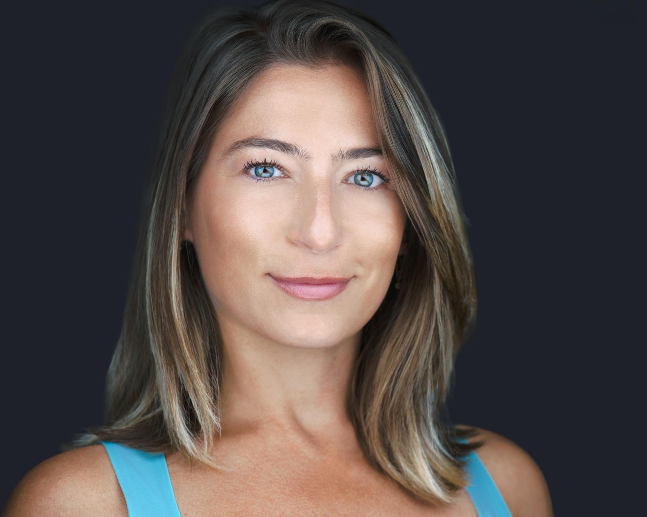 Professional headshot of a male executive wearing glasses with modern lighting