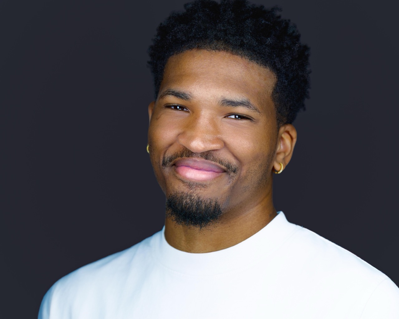 Modern corporate headshot of a young professional with clean studio lighting