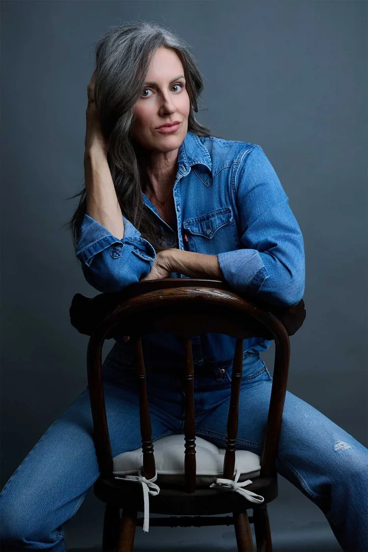 Professional portrait example for the VIP Session package by Deborah Heinlen Photography, Cincinnati — confident woman with gray hair in denim shirt against gray studio background