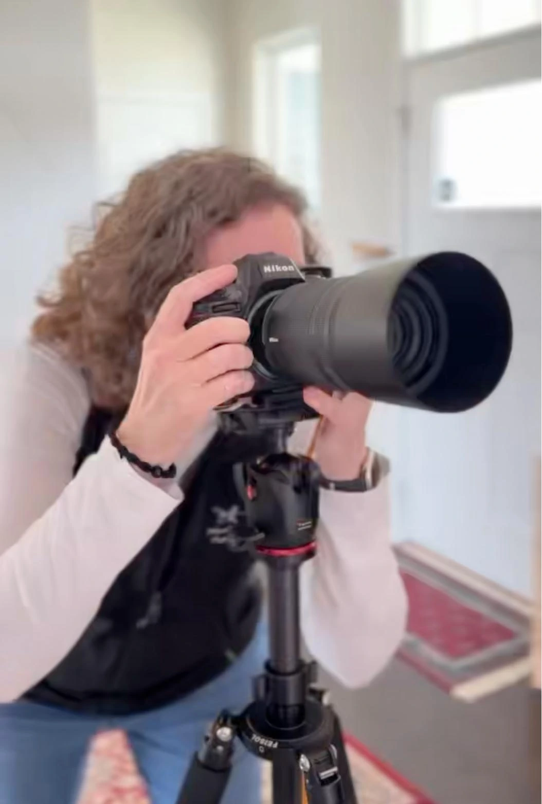 Deborah Heinlen, Cincinnati headshot and corporate event photographer, photographing a client session with a Nikon camera and telephoto lens